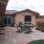 Patio complete with spa and furniture. Fencing provides privacy from neighbors as well as concealing utility areas.