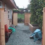 Cordoned of with fincing and gates on either side, this is the perfect utility spot. Out of sight, out of mind. Granite gravel provides an inexpensive flooring material.